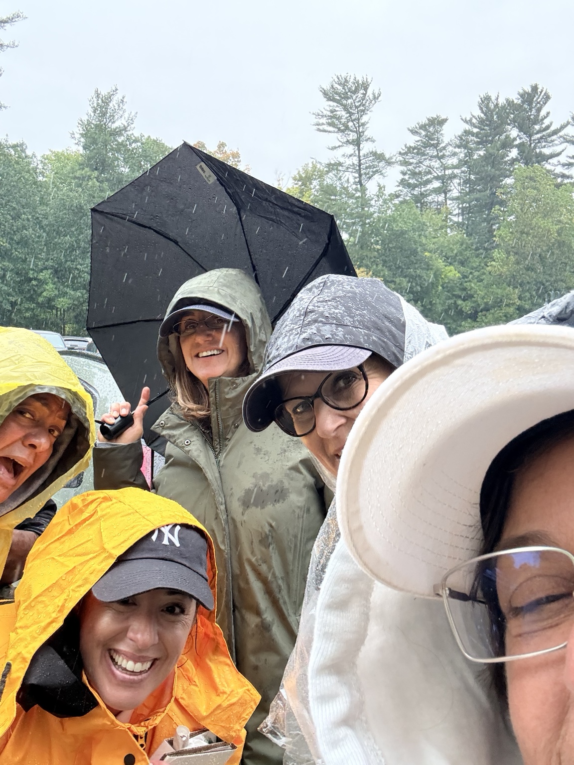 Hawks supporters smiling together in rain gear